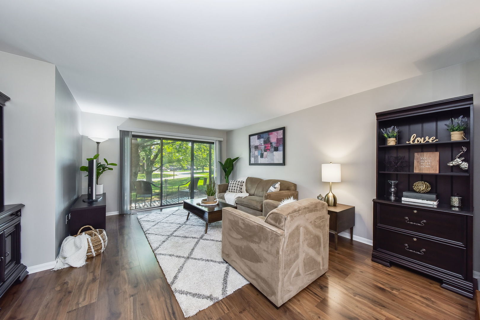 367 Sandhurst Circle, Unit 5 Glen Ellyn, IL 60137 - Photo 4 of 10 a living room with furniture hard wood floor and a floor to ceiling window