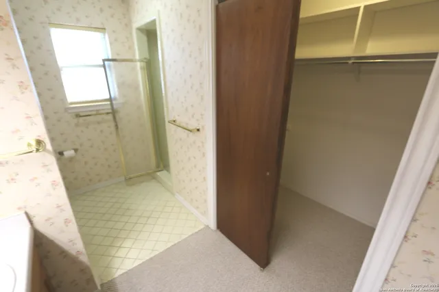 a bathroom with a glass shower door