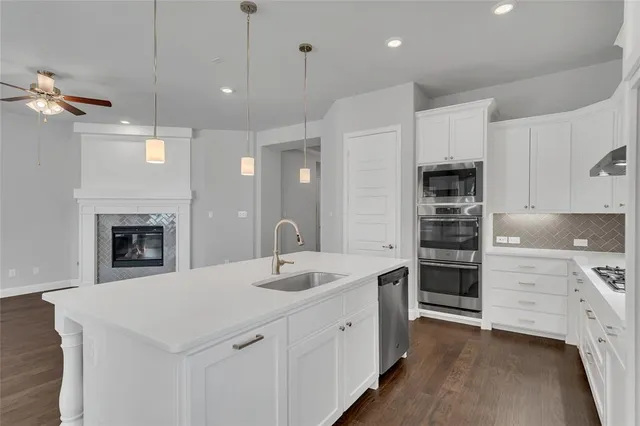a kitchen with a sink and a stove top oven
