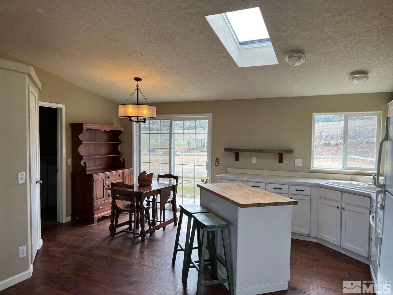 3395 Basque Oven Road Reno, NV 89510 - Photo 29 of 40 a kitchen with a stove a sink dishwasher a refrigerator with a dining table and chair