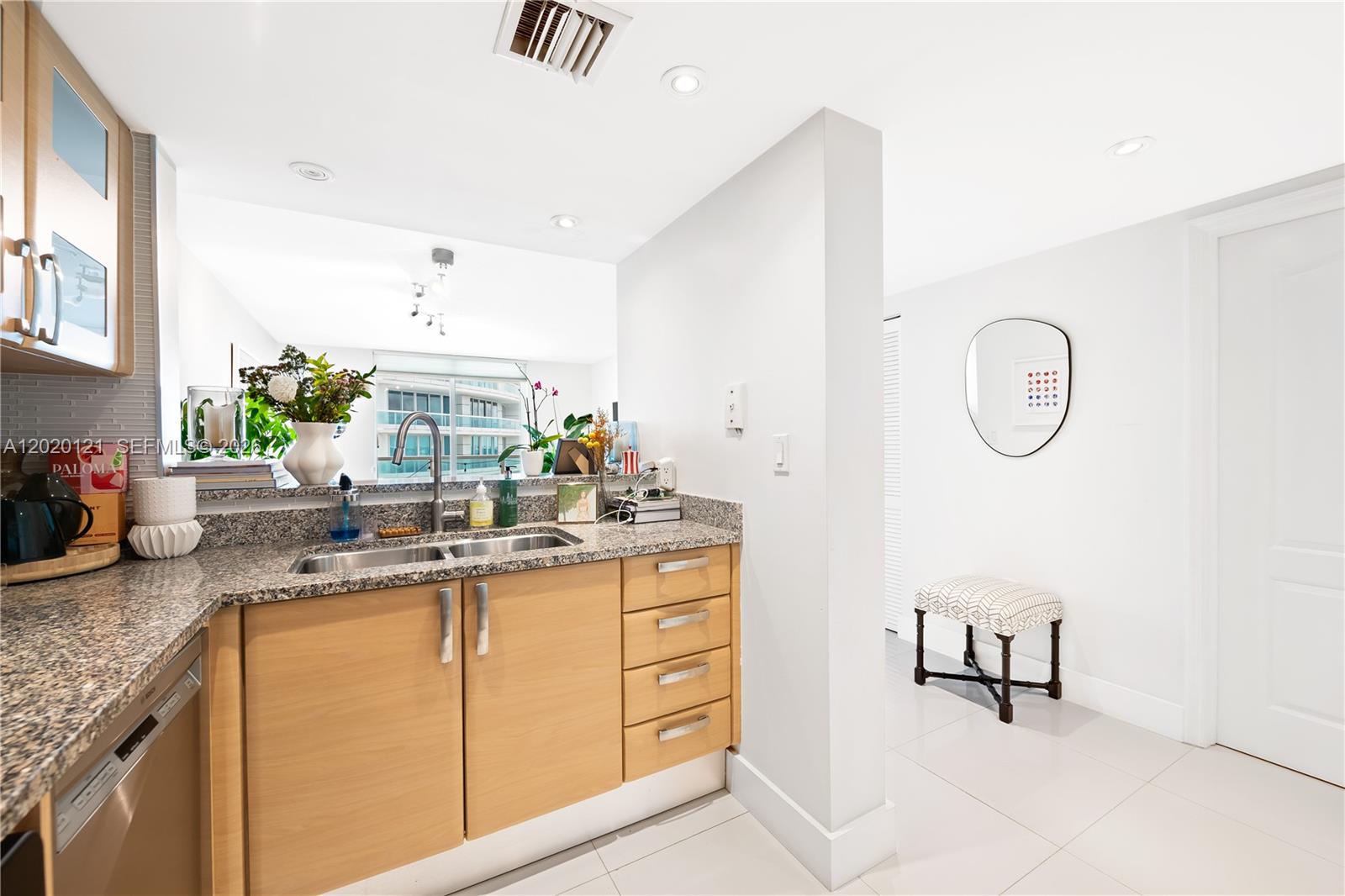 2101 Brickell Avenue, Unit 1909 Miami, FL 33129 - Photo 7 of 25 a kitchen with granite countertop a sink a stove and a wooden floors