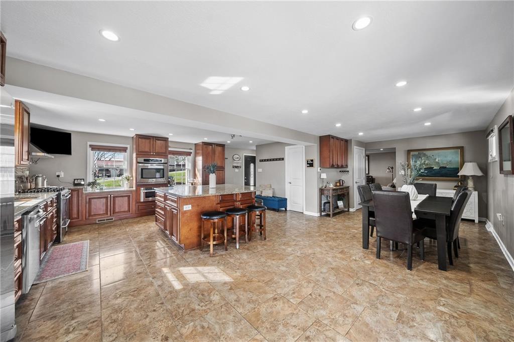 3032 Investors Road Washington, PA 15301 - Photo 12 of 50 Open eat-in kitchen with a large island connecting to the dining area, creating a seamless space for hosting 20+ guests.