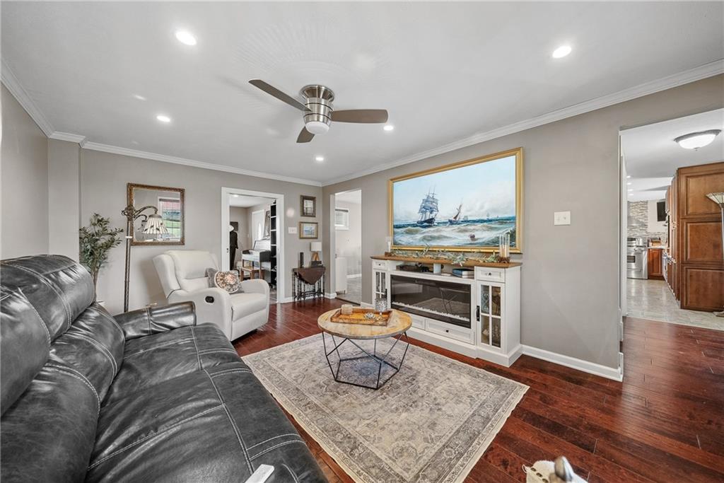3032 Investors Road Washington, PA 15301 - Photo 17 of 50 Spacious living room just off the kitchen and dining area, a perfect spot for movie nights or entertaining while staying connected to guests.
