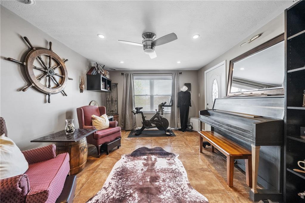 3032 Investors Road Washington, PA 15301 - Photo 19 of 50 Private den off the living room with pocket doors, perfect for a playroom, office, or quiet retreat, with convenient access to the outdoor deck.