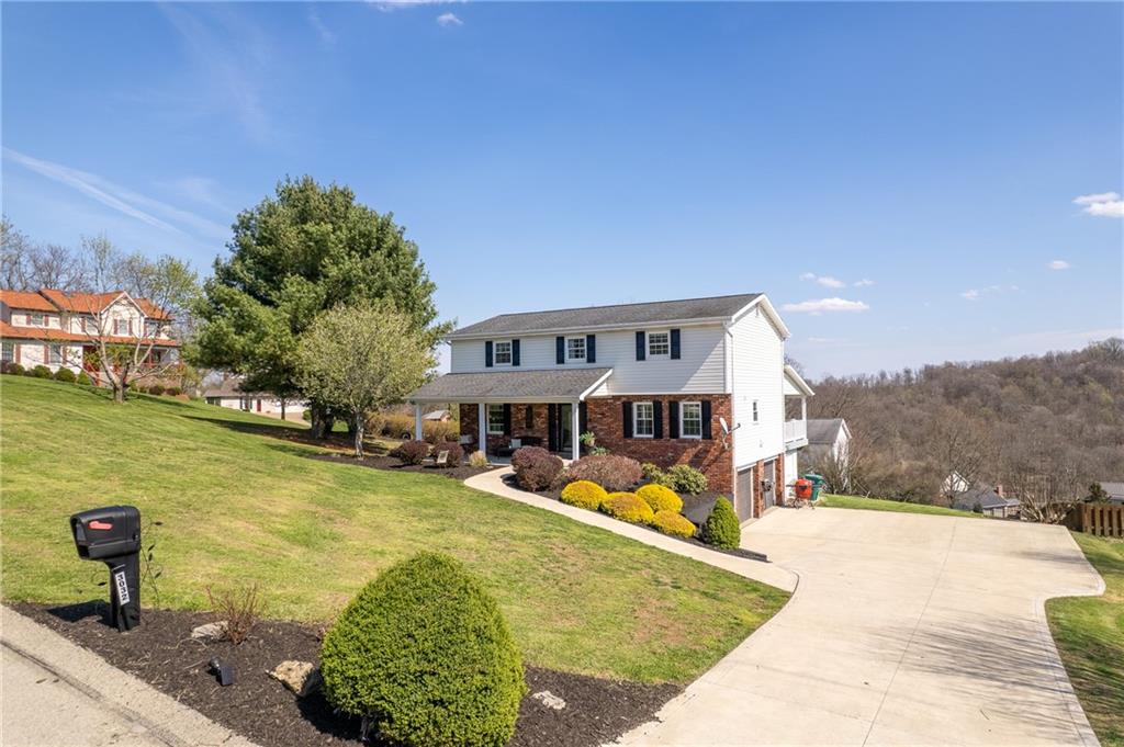 3032 Investors Road Washington, PA 15301 - Photo 2 of 50 Solid and well-designed 4-bedroom home in Franklin Manor featuring a 2-car side-entry integral garage, situated on a 0.5 acre corner lot with a concrete driveway and covered front porch.