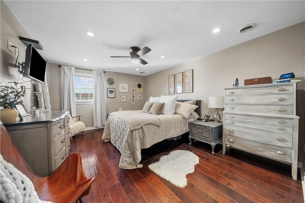 3032 Investors Road Washington, PA 15301 - Photo 22 of 50 Owner’s suite positioned in its own private section of the home, offering a spacious bedroom, walk-in closet with custom organization, and a spa-style bathroom with soaking tub, dual vanities, stand-up shower, and stackable washer and dryer.