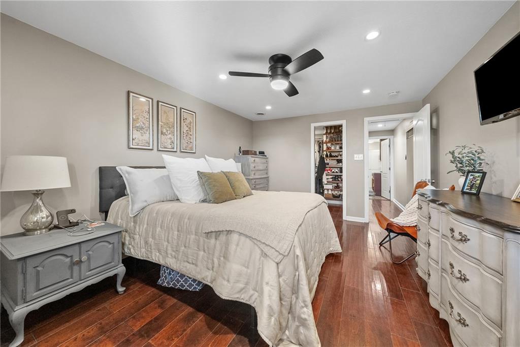 3032 Investors Road Washington, PA 15301 - Photo 23 of 50 Owner’s suite positioned in its own private section of the home, offering a spacious bedroom, walk-in closet with custom organization, and a spa-style bathroom with soaking tub, dual vanities, stand-up shower, and stackable washer and dryer.