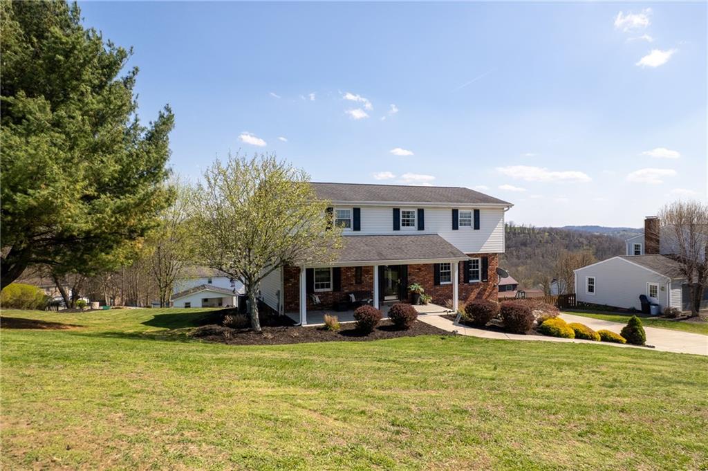 3032 Investors Road Washington, PA 15301 - Photo 3 of 50 Solid and well-designed 4-bedroom home in Franklin Manor featuring a 2-car side-entry integral garage, situated on a 0.5 acre corner lot with a concrete driveway and covered front porch.