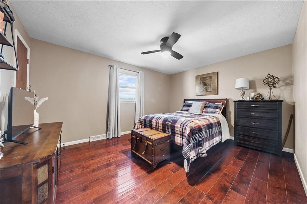 3032 Investors Road Washington, PA 15301 - Photo 32 of 50 Spacious secondary bedroom, formerly the owner’s bedroom, featuring an ensuite bathroom with stand-up shower and single vanity, along with a walk-in closet.
