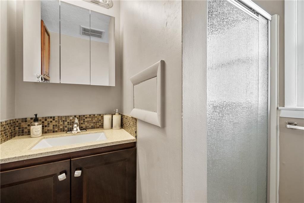 3032 Investors Road Washington, PA 15301 - Photo 33 of 50 Spacious secondary bedroom, formerly the owner’s bedroom, featuring an ensuite bathroom with stand-up shower and single vanity, along with a walk-in closet.