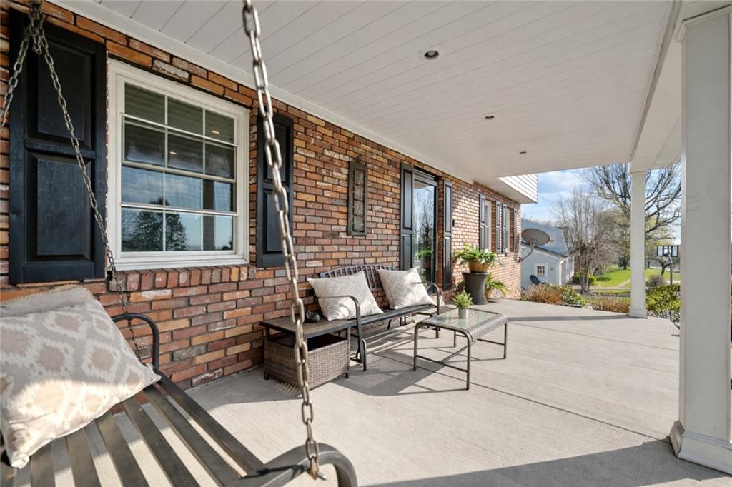 3032 Investors Road Washington, PA 15301 - Photo 4 of 50 Enjoy the covered front porch, a welcoming space to relax, unwind, or gather that also adds to the home’s curb appeal.