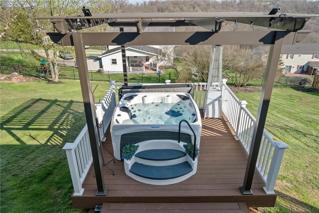 3032 Investors Road Washington, PA 15301 - Photo 44 of 50 New composite lower deck built in 2023 with a hot tub and pergola, creating a private outdoor retreat, all included with the property.