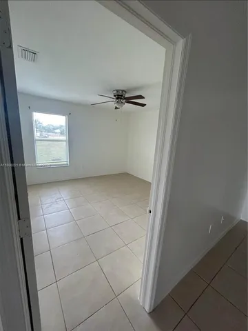 a bathroom with a granite countertop sink a mirror and a toilet