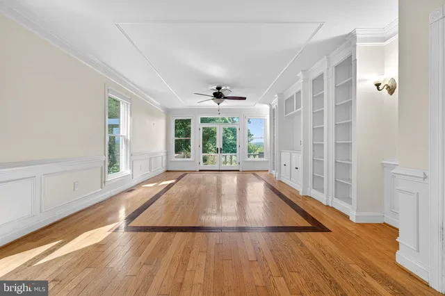 a kitchen with stainless steel appliances granite countertop a refrigerator oven a sink dishwasher and white cabinets next to a window