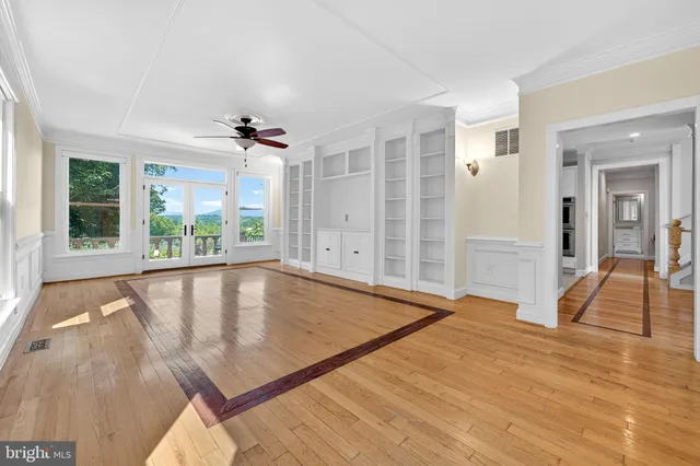 a large white kitchen with cabinets