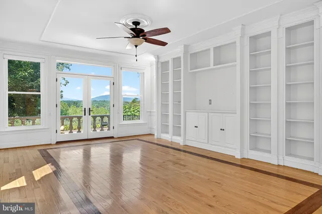 a kitchen with granite countertop white cabinets and stainless steel appliances