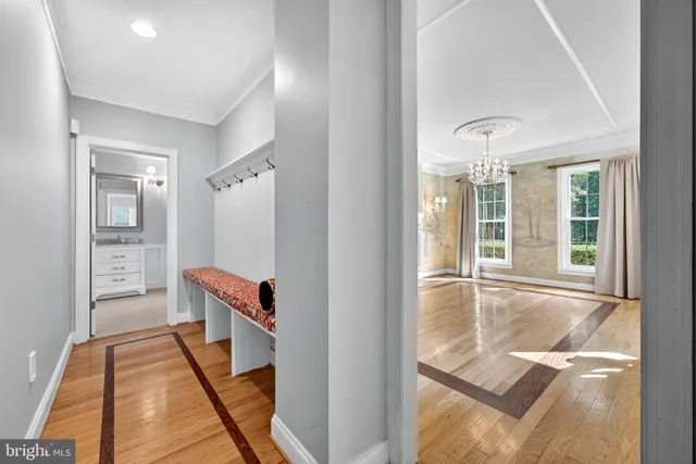 a view of a hallway with wooden floor and stairs