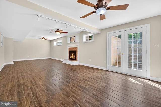 a bathroom with a granite countertop sink a toilet mirror and bathtub