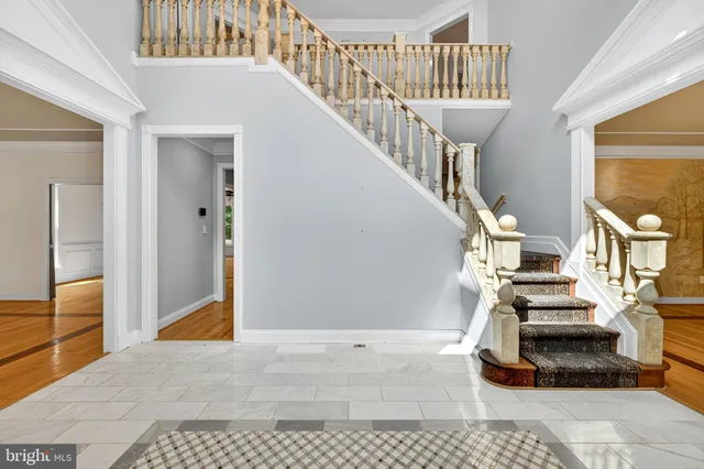 a view of empty room with wooden floor and fireplace