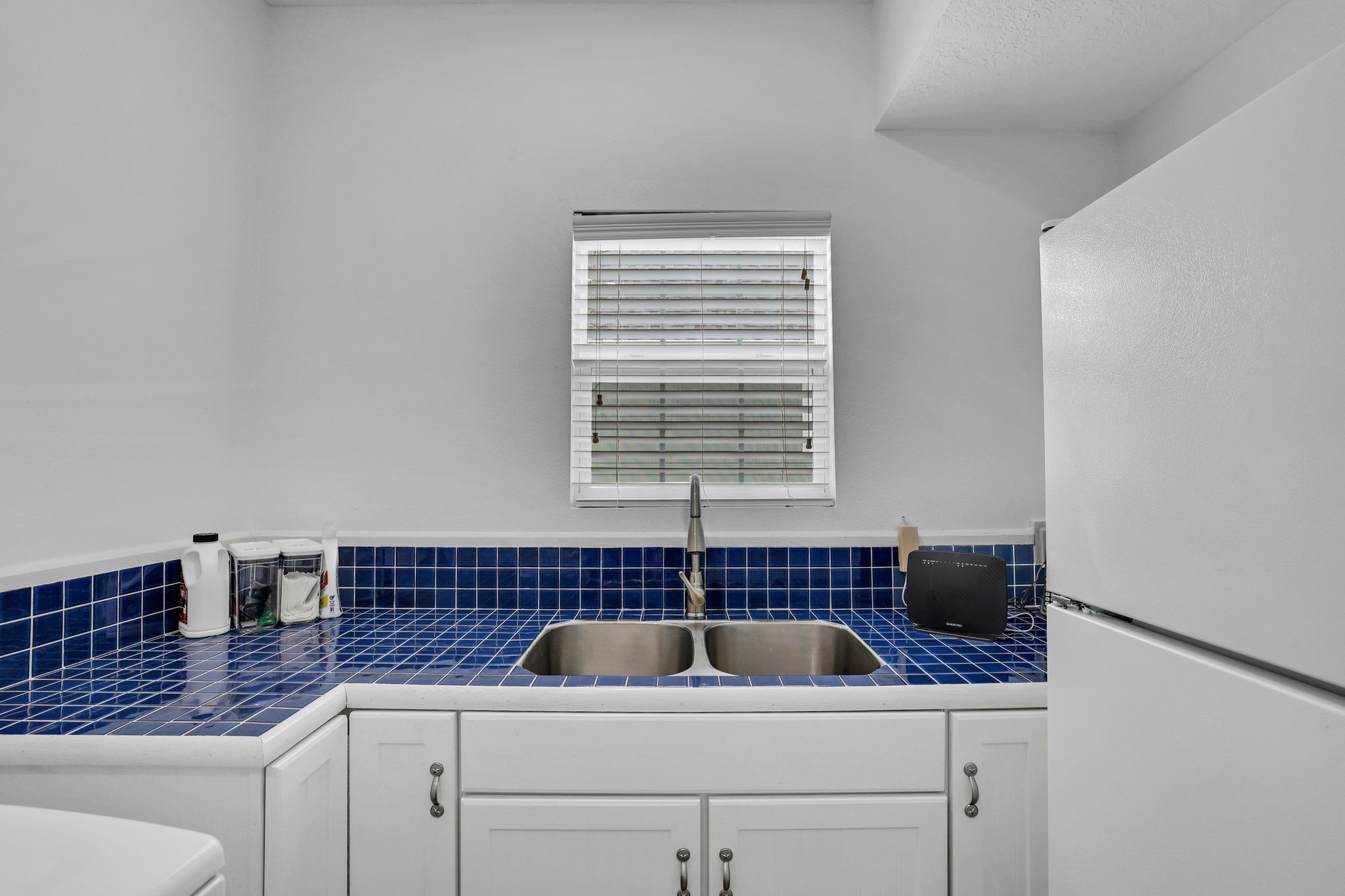331 Holiday Lane Coldspring, TX 77331 - Photo 13 of 36 The first floor in-house laundry room with a sink and ample counter tops is spacious enough for an extra fridge.
