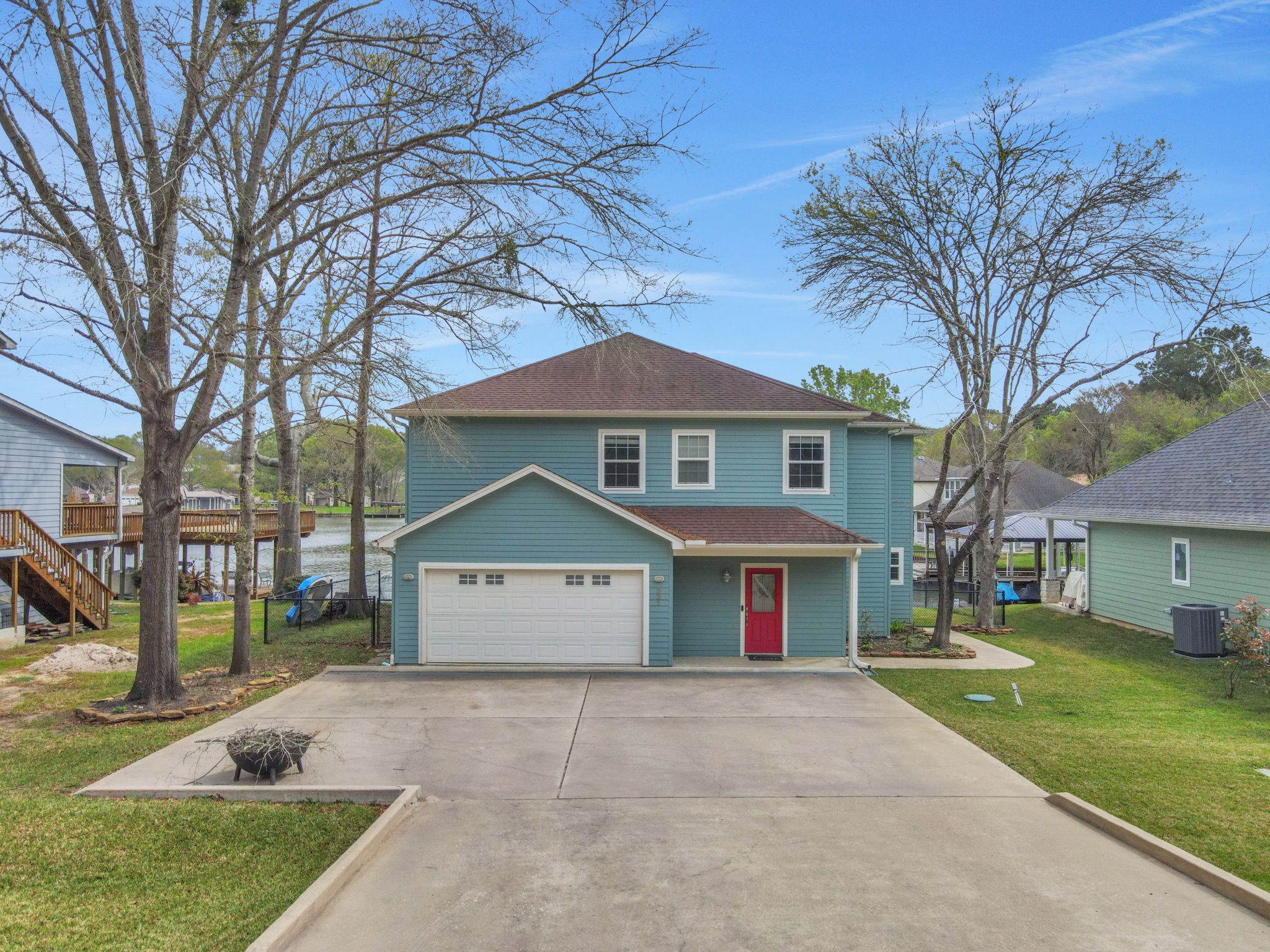 331 Holiday Lane Coldspring, TX 77331 - Photo 2 of 36 The front of the home highlights the convenient attached garage and the wide driveway for extra parking.