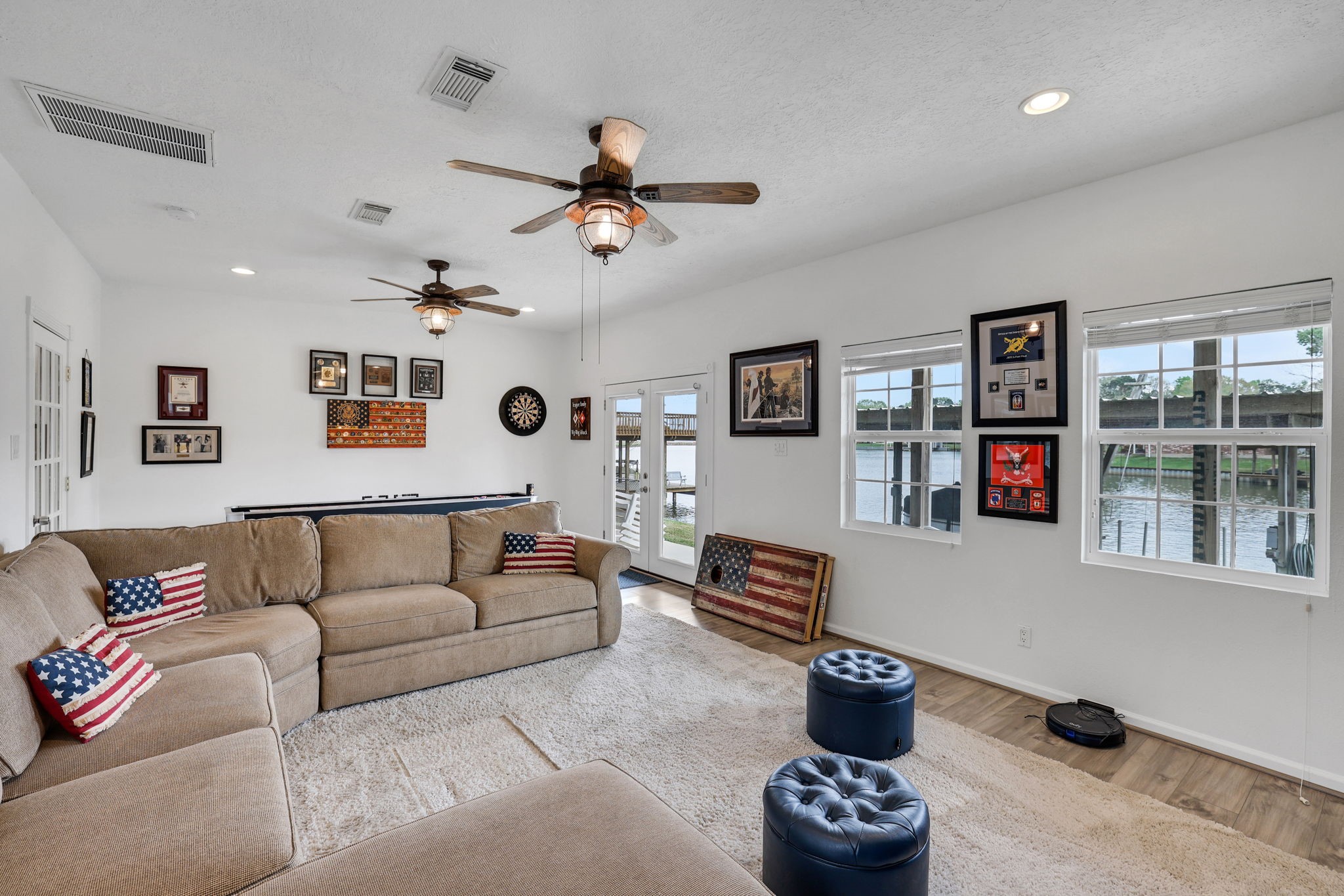 331 Holiday Lane Coldspring, TX 77331 - Photo 9 of 36 This spacious first floor living area offers views of the lake and a cozy atmosphere, ideal for relaxation and entertainment.