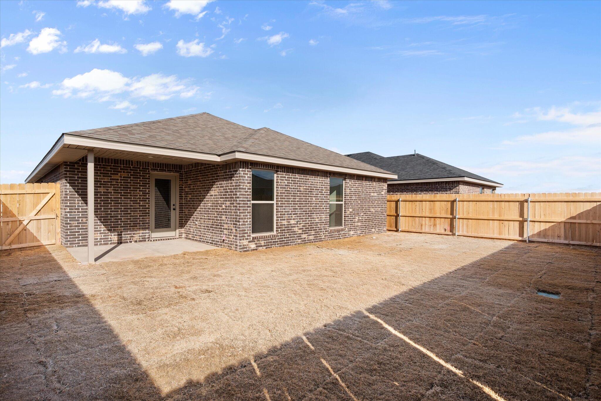 7203 7th Street Lubbock, TX 79416 - Photo 19 of 20 a front view of a house with a yard