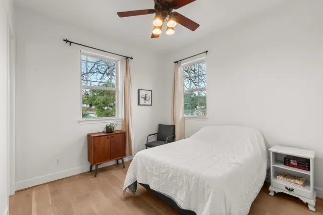 a bedroom with a bed dresser and a window