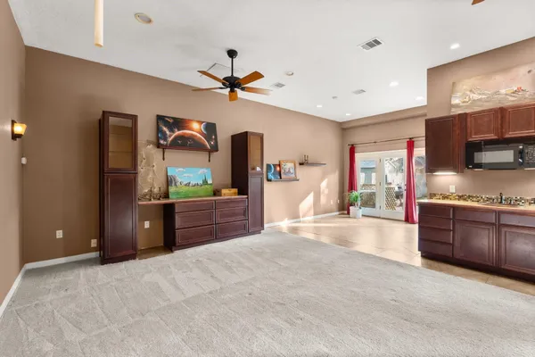 a large bedroom with a large bed and a chandelier