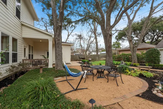 a view of a backyard with sitting area