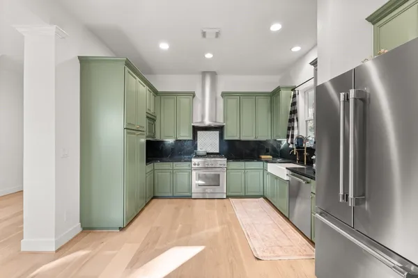 a kitchen with a refrigerator and a sink
