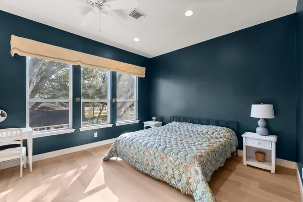 a bedroom with a bed and a large window