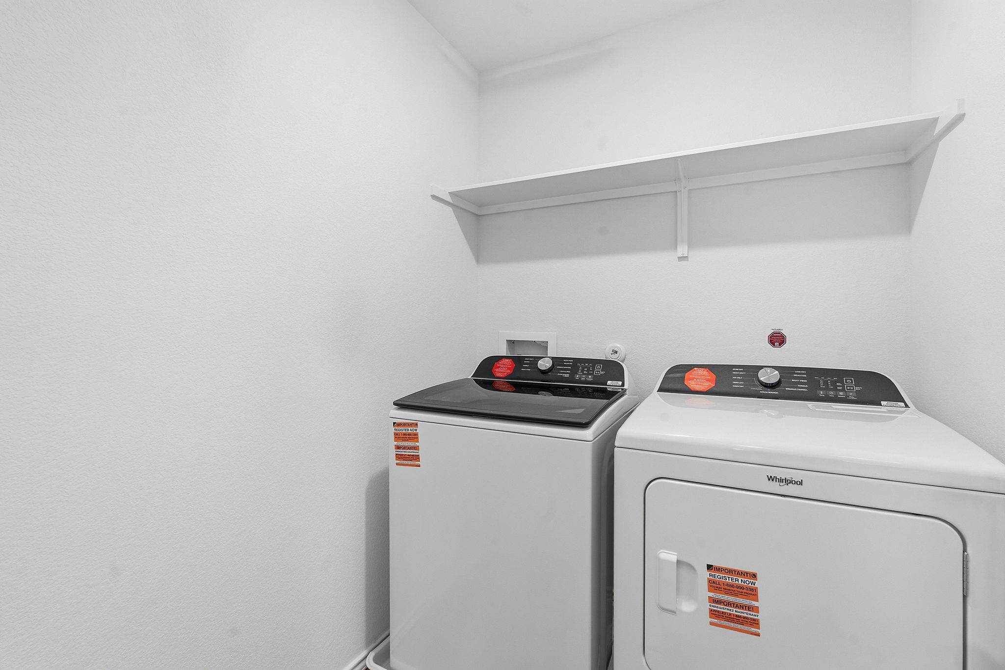 164 Cinnabar Lane, Unit 2 Kyle, TX 78640 - Photo 19 of 21 Dedicated laundry area featuring a white washer and dryer set, a wall-mounted storage shelf, and white painted walls