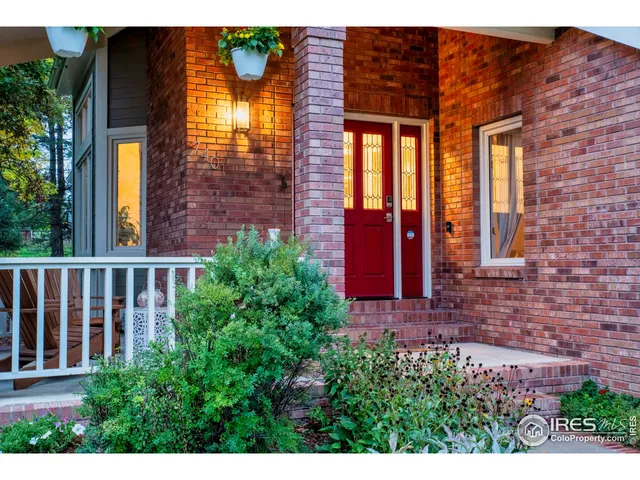 a view of a brick house with many windows and a yard