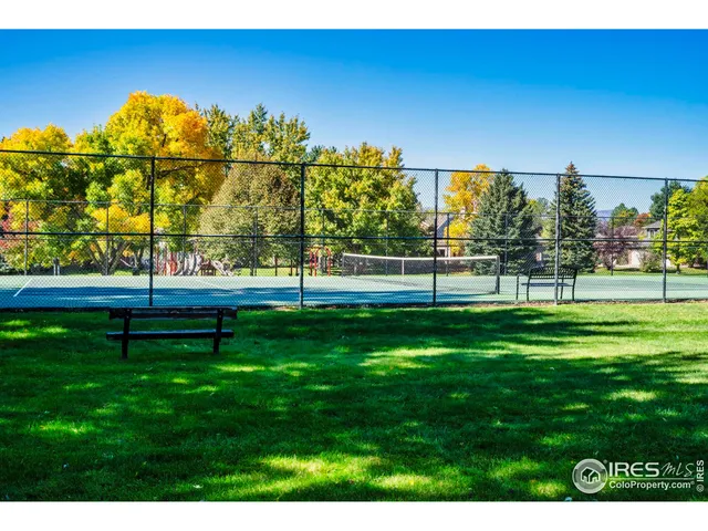 a view of a table and chairs under an umbrella