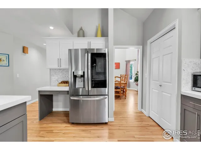 a living room with stainless steel appliances kitchen island granite countertop furniture