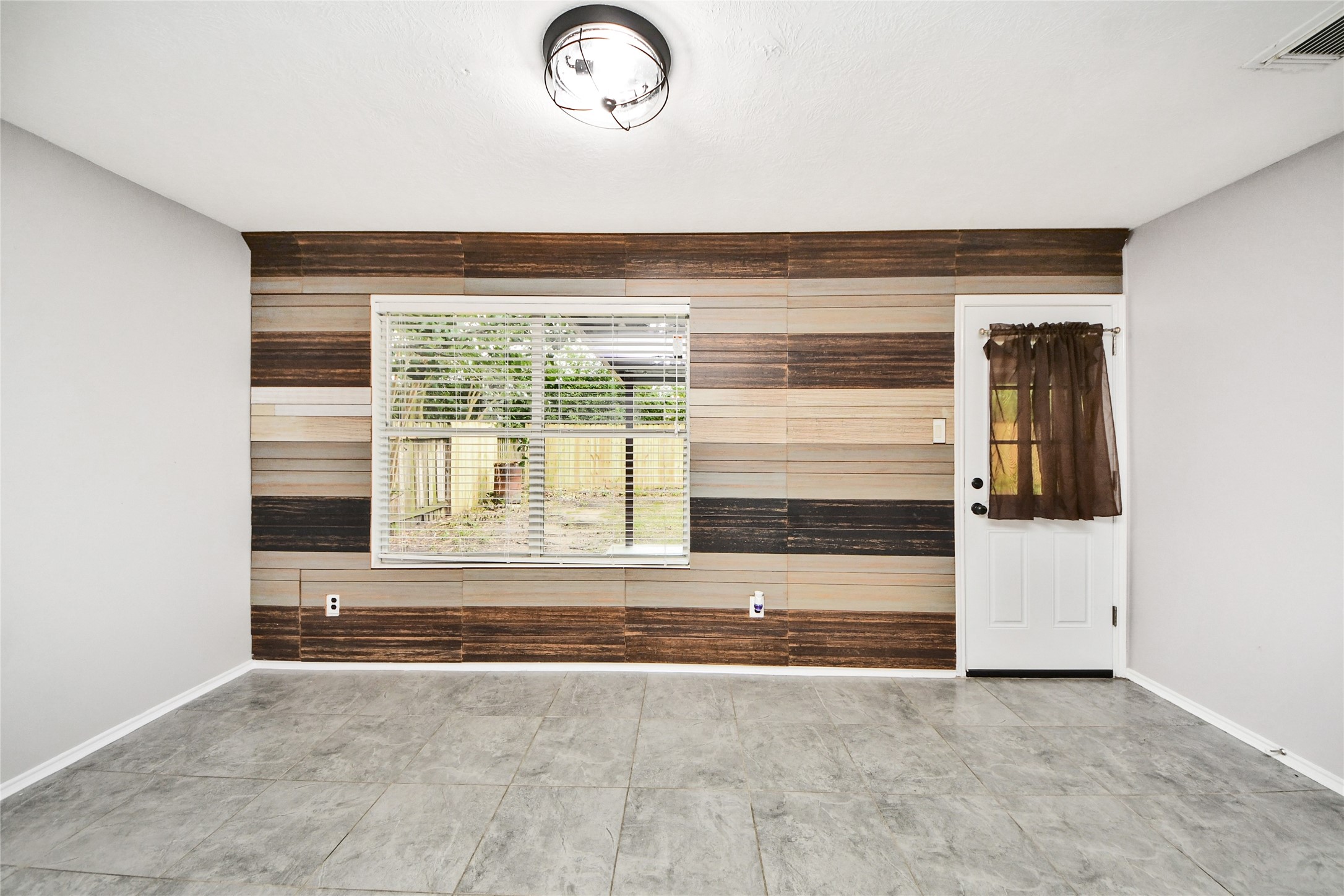 24019 Kingbriar Drive Spring, TX 77373 - Photo 20 of 41 A dedicated space for casual dining characterized by its beautiful wood-textured feature wall and a large window that invites plenty of natural light.