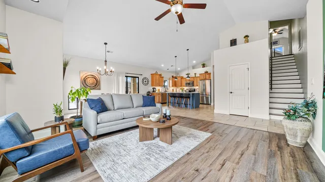 a living room with furniture and wooden floor