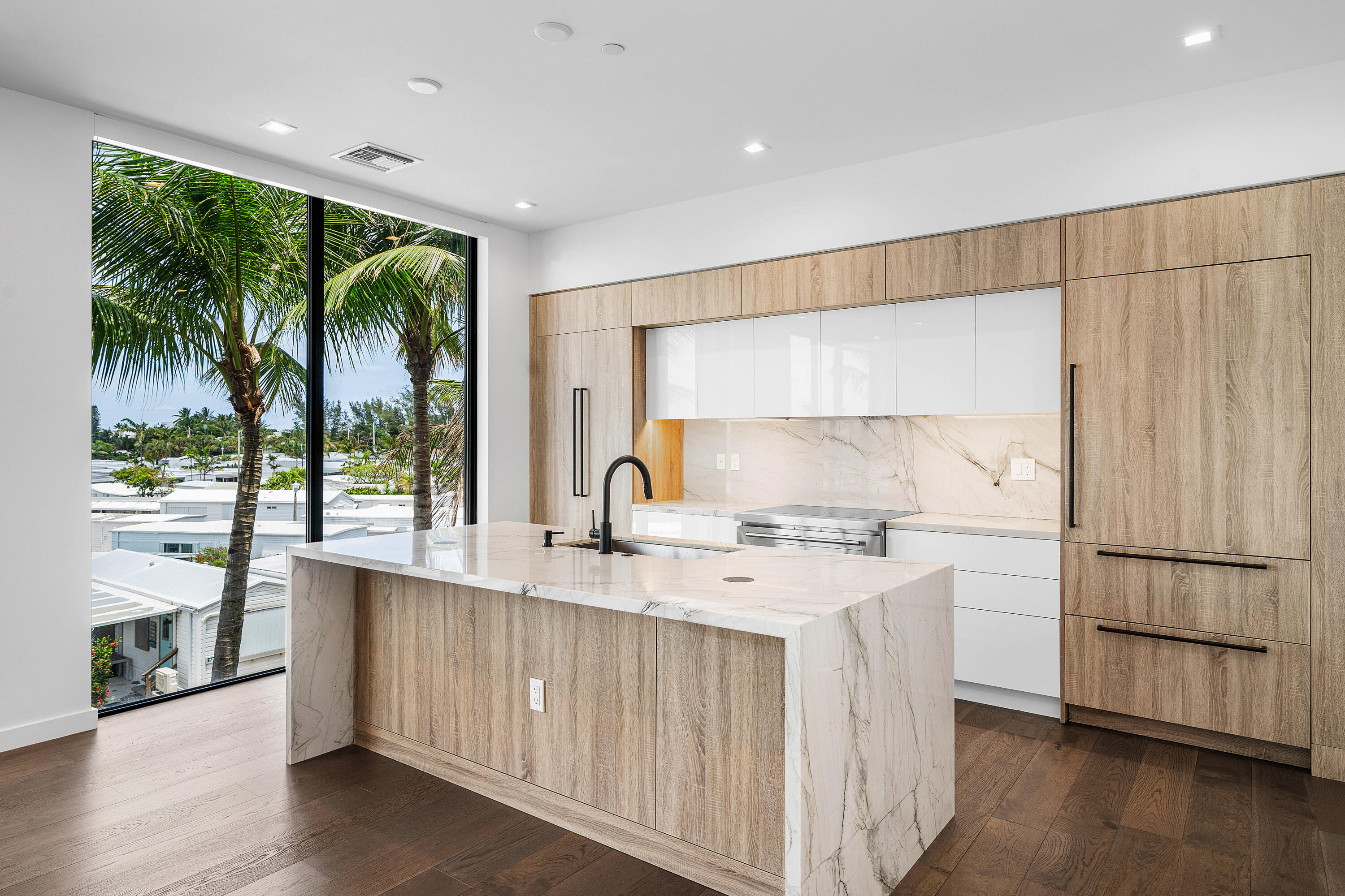 11505 Old Ocean Boulevard Ocean Ridge, FL 33435 - Photo 11 of 35 a kitchen with a sink a counter top space and stainless steel appliances