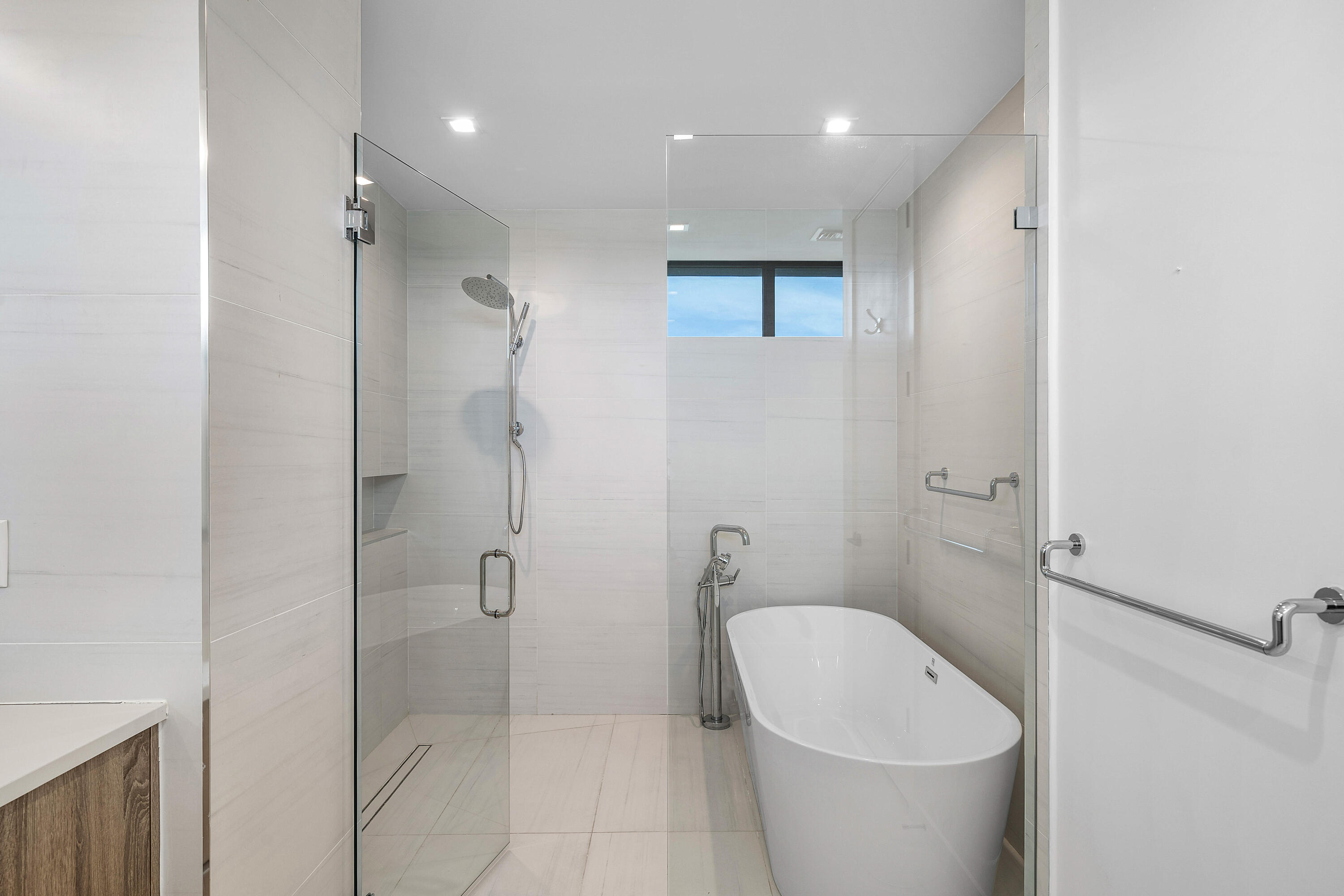 11505 Old Ocean Boulevard Ocean Ridge, FL 33435 - Photo 16 of 35 a bathroom with a white bath tub a toilet and a shower