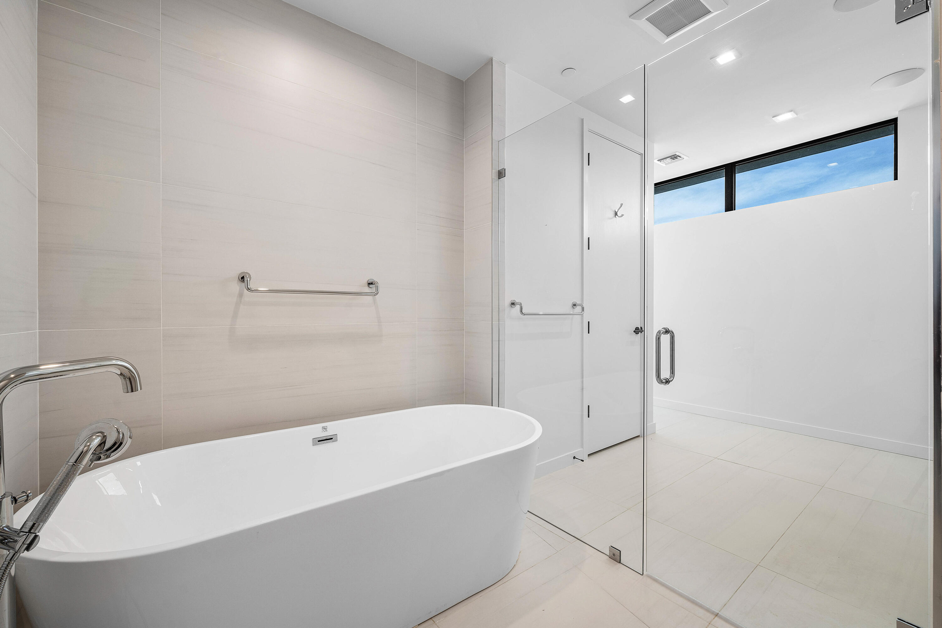 11505 Old Ocean Boulevard Ocean Ridge, FL 33435 - Photo 17 of 35 a white bath tub sitting in a bathroom