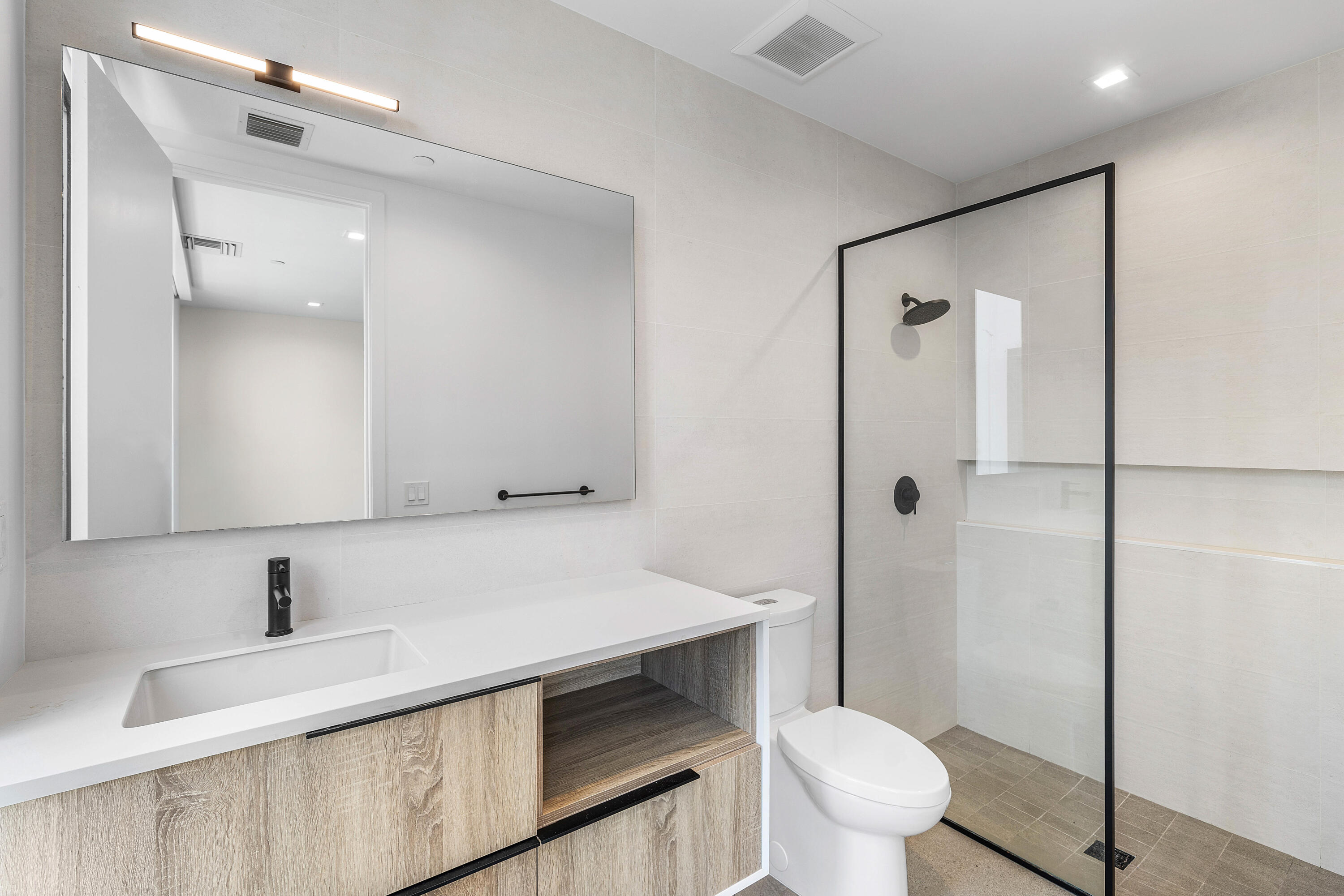 11505 Old Ocean Boulevard Ocean Ridge, FL 33435 - Photo 20 of 35 a bathroom with a sink a toilet and shower