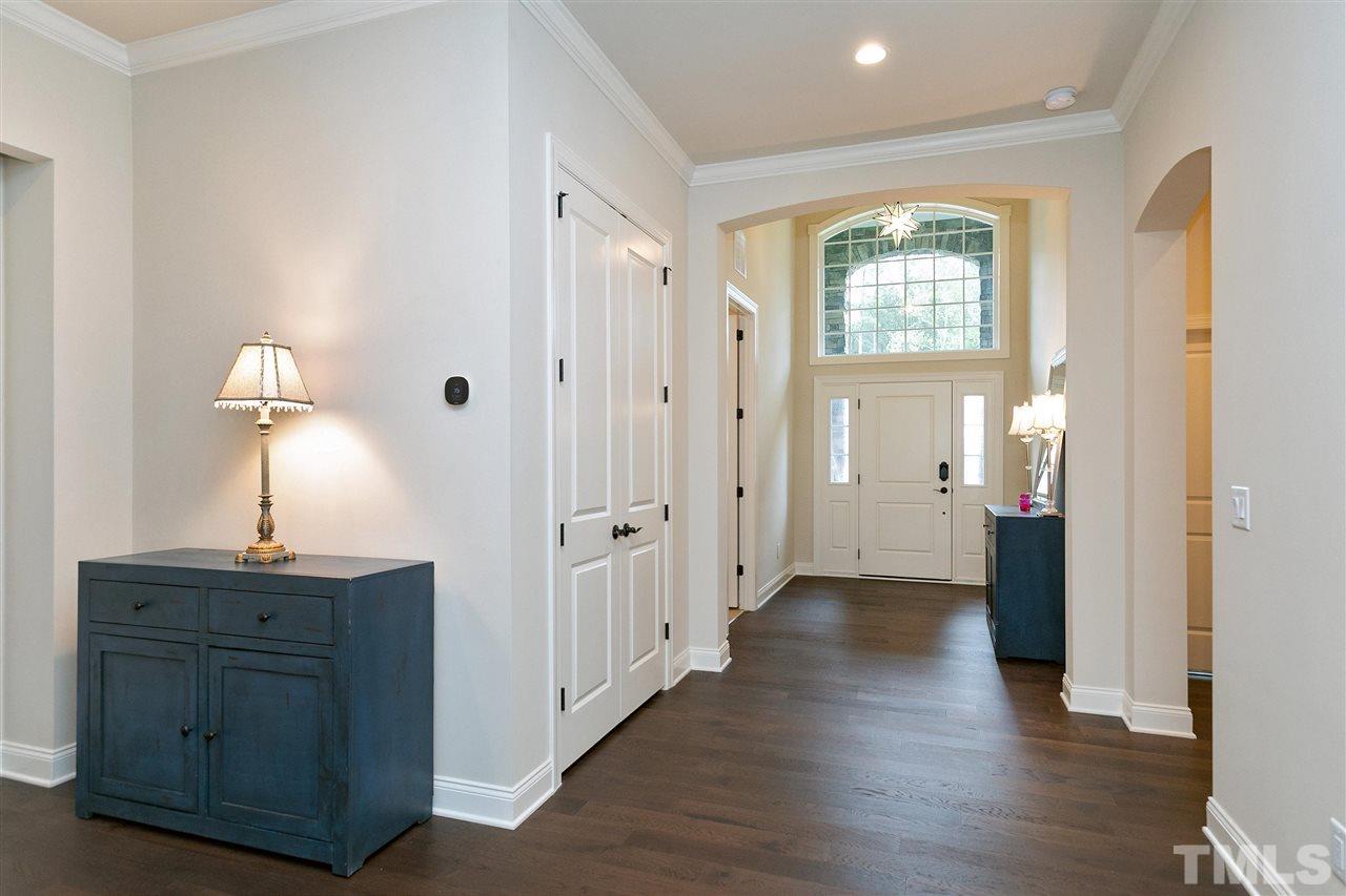 2519 Range Overlook Crossing Apex, NC 27523 - Photo 5 of 26 a view of an empty room with wooden floor and a window