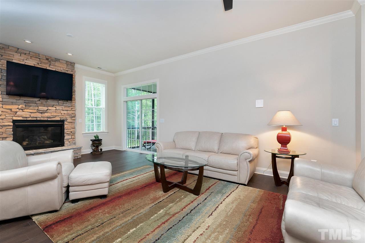 2519 Range Overlook Crossing Apex, NC 27523 - Photo 6 of 26 a living room with furniture fireplace and a flat screen tv
