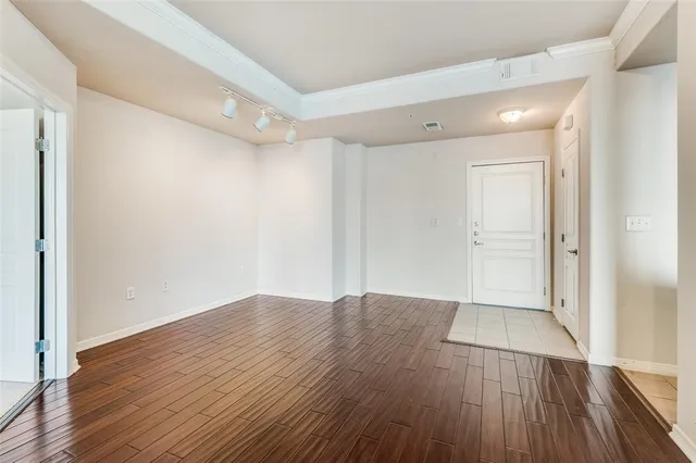 a view of an empty room with wooden floor