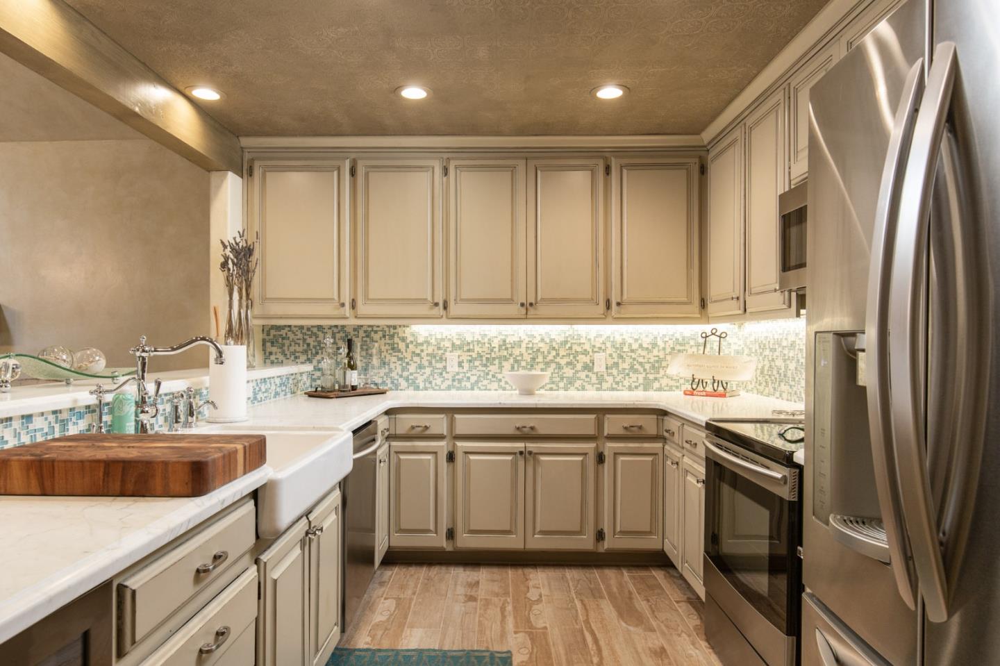 0 Southwest Sw Corner, Unit F Carmel, CA 93921 - Photo 11 of 19 a kitchen with a sink stove cabinets and refrigerator