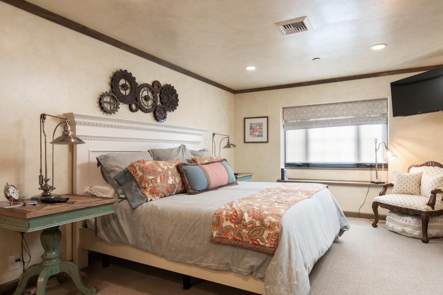 0 Southwest Sw Corner, Unit F Carmel, CA 93921 - Photo 16 of 19 a bedroom with a large bed and a couch