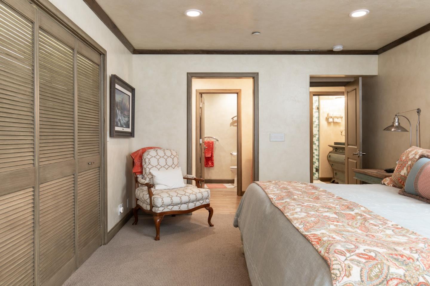 0 Southwest Sw Corner, Unit F Carmel, CA 93921 - Photo 17 of 19 a bedroom with a bed and a chandelier