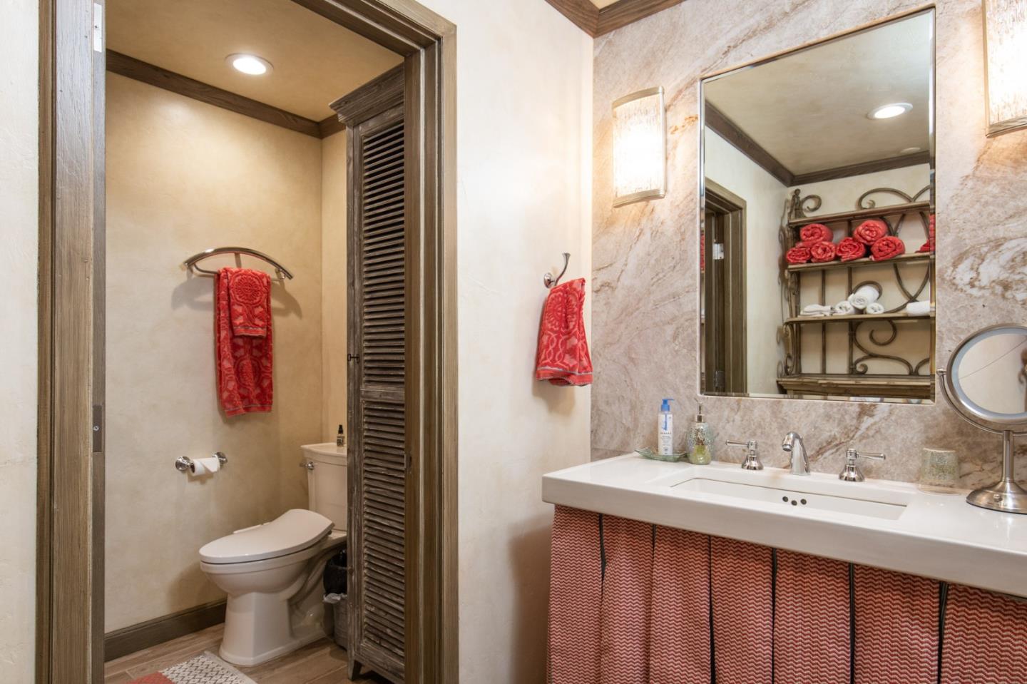 0 Southwest Sw Corner, Unit F Carmel, CA 93921 - Photo 18 of 19 a bathroom with a toilet sink and mirror