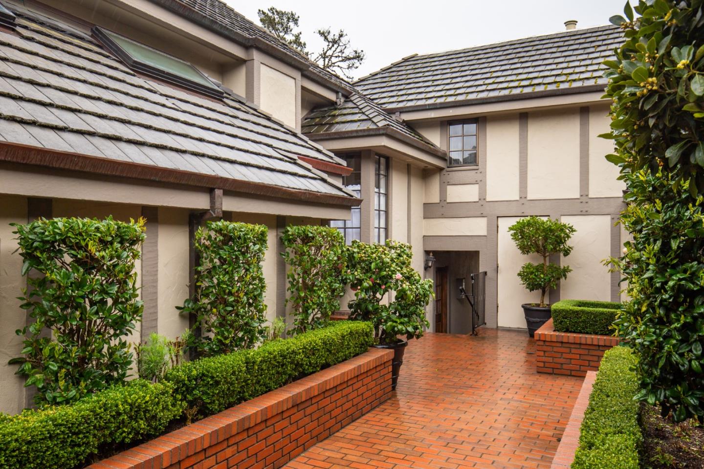 0 Southwest Sw Corner, Unit F Carmel, CA 93921 - Photo 3 of 19 a house with potted plants in front of it
